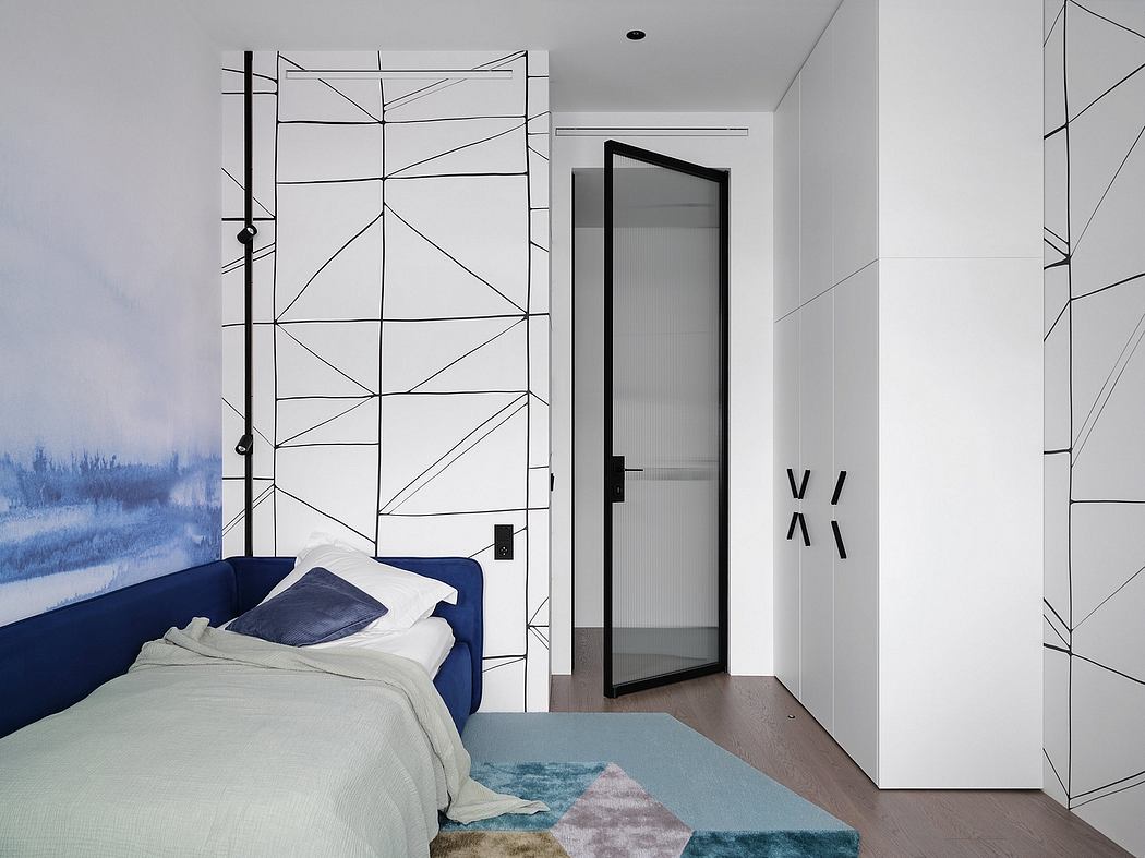 Minimalist bedroom with geometric patterned wall, navy blue bedding, and a black framed door.