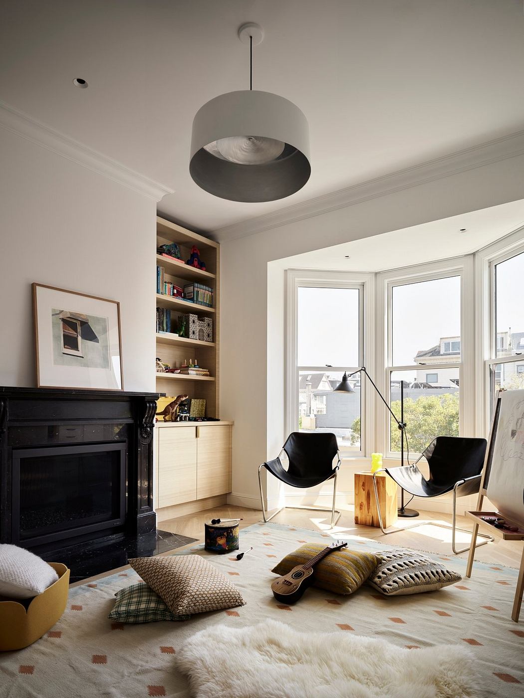 Cozy living room with a black fireplace, built-in shelves, and modern furnishings.