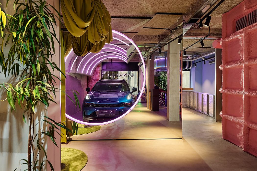 Vibrant, modern office space with bold purple arches, plants, and a futuristic vehicle display.