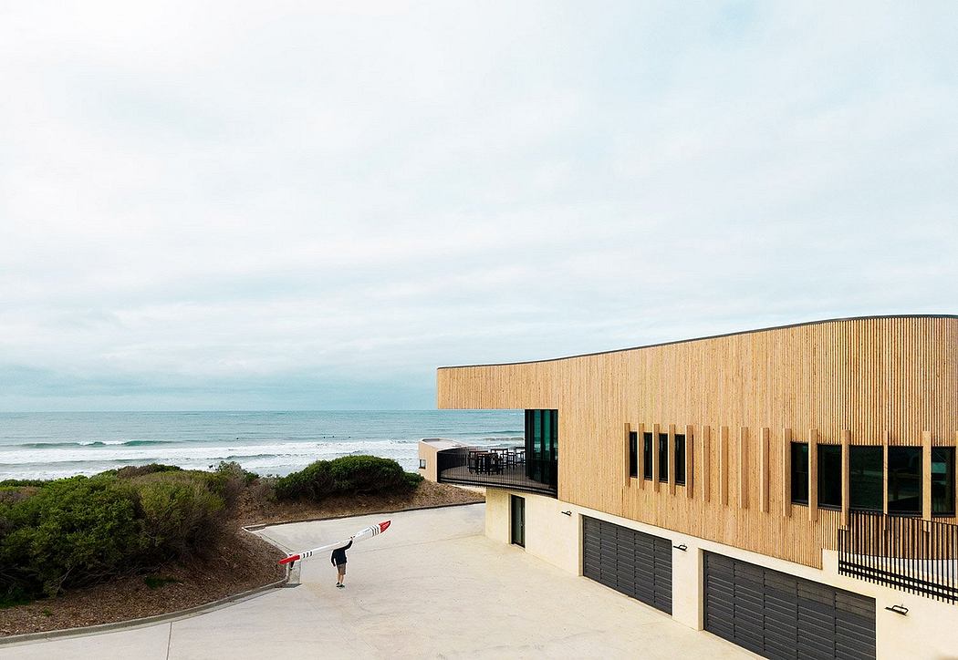 Striking coastal building with wooden facade and balanced architectural elements.