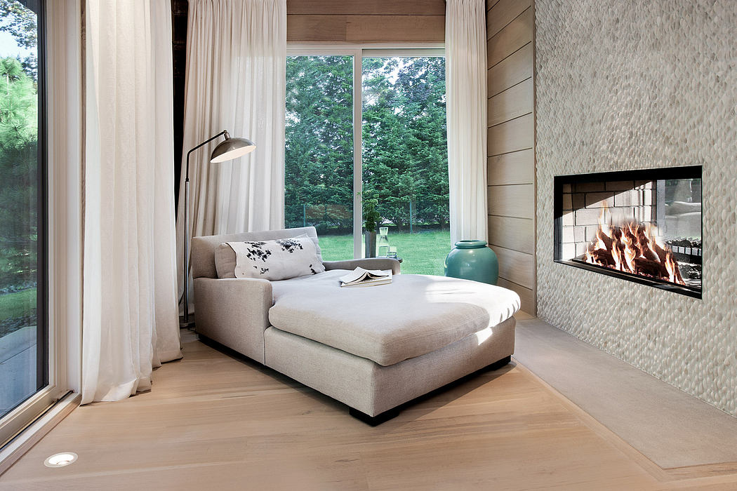 Elegant modern living space with large windows, plush seating, and a cozy fireplace.