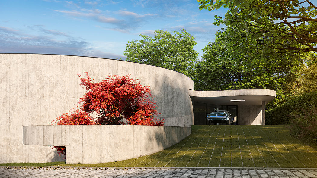 Curved concrete building with vibrant red tree, paved courtyard and car garage.