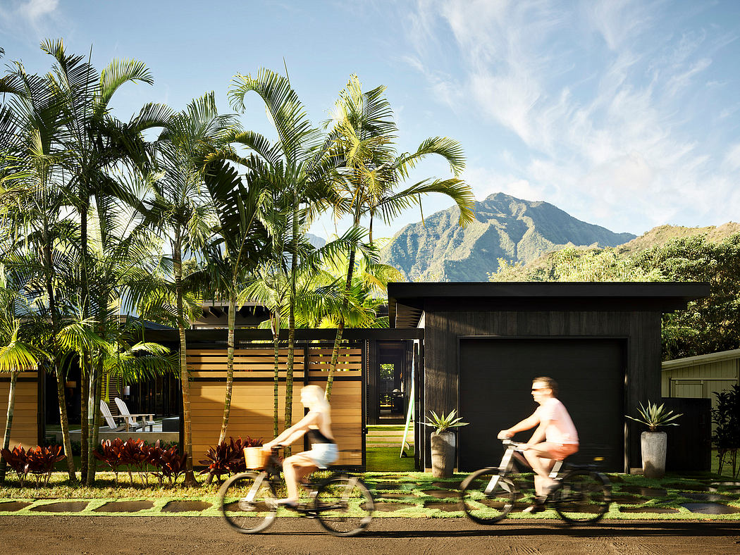Tropical modernist architecture with palm trees and people cycling in the foreground.