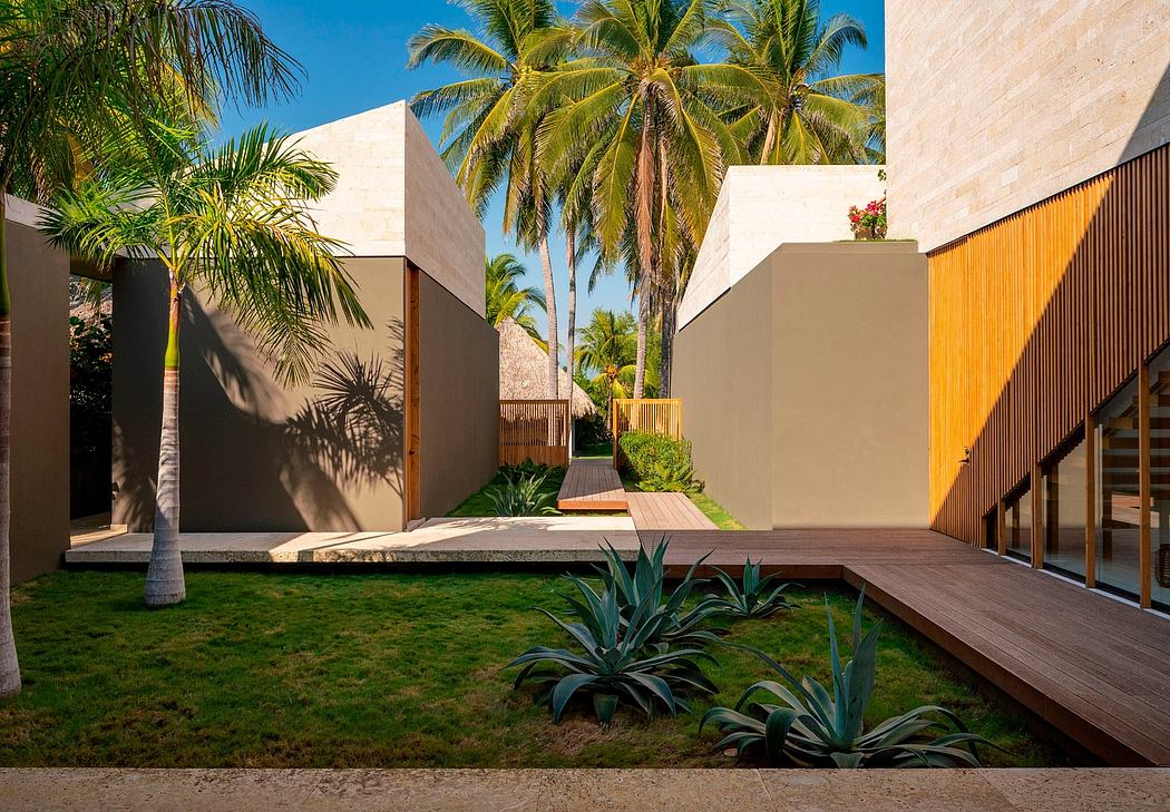 Minimalist architecture with palm trees, lush plants, and wooden decking creating a tropical oasis.