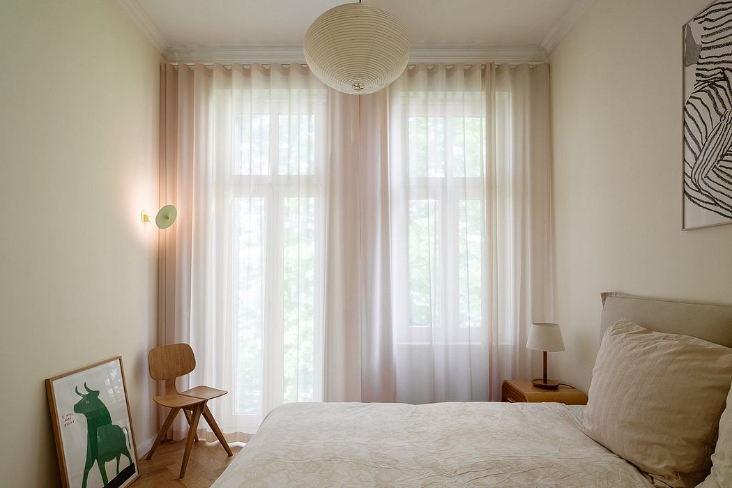 Minimalist bedroom with large windows, sheer curtains, and a modern pendant light fixture.
