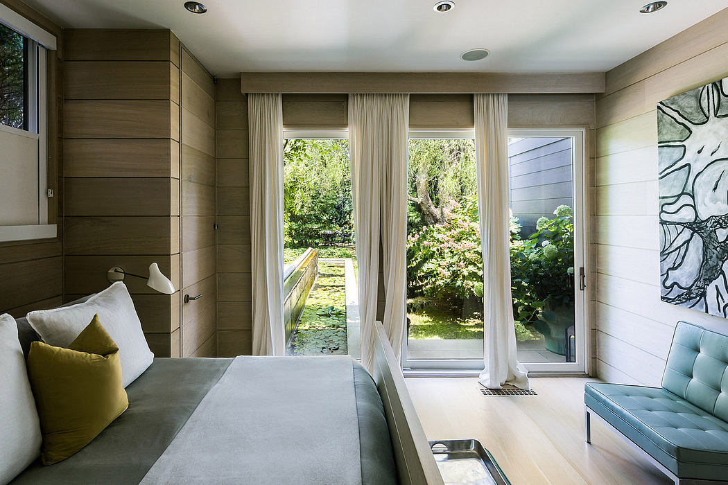 Expansive windows overlook a verdant landscape, creating a tranquil, nature-inspired environment.