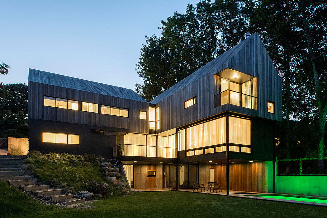 Striking modern architecture with clean lines, large windows, and lush natural surroundings.