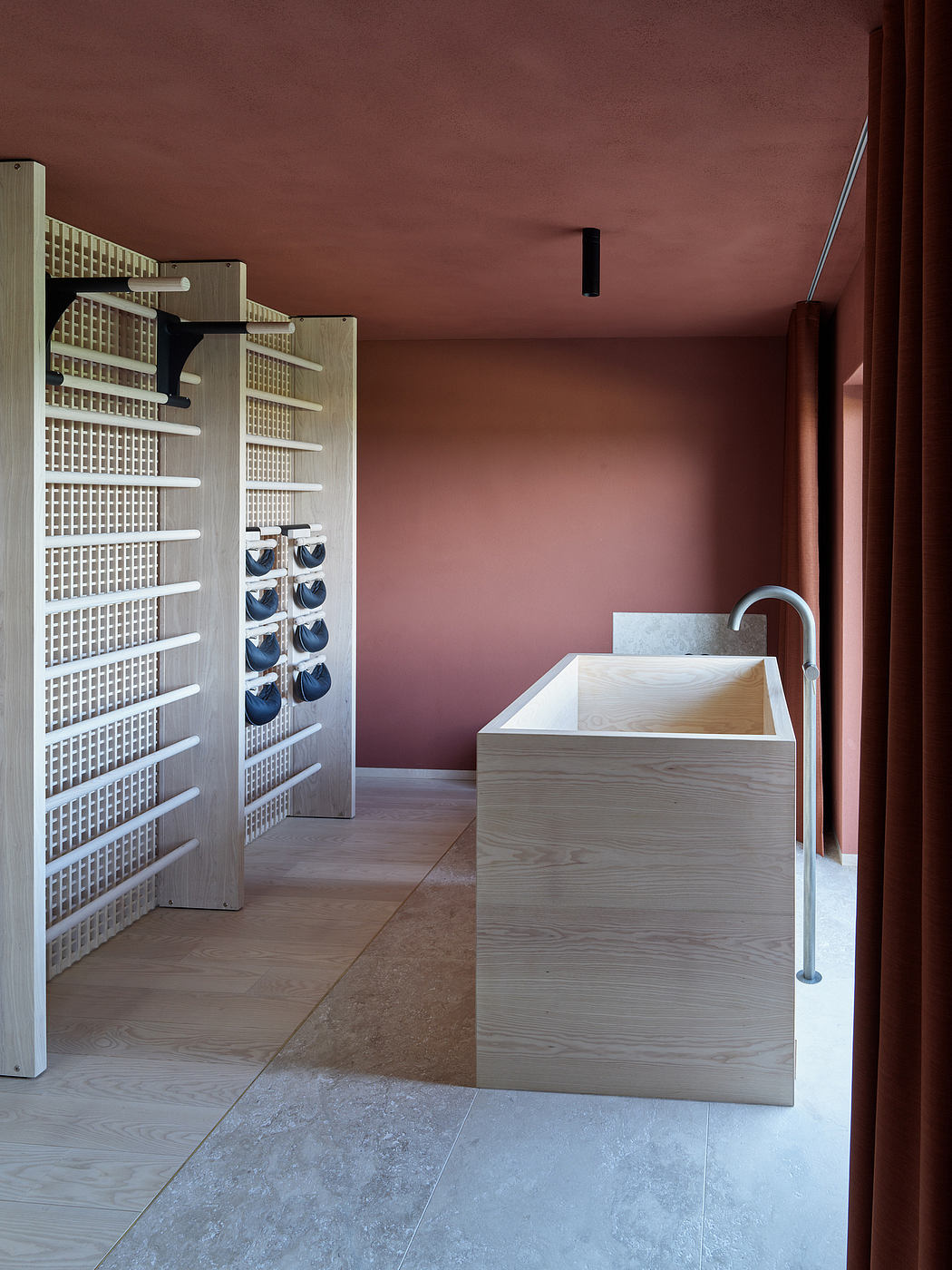Minimalist bathroom with textured wall, wooden vanity, and modular storage units.