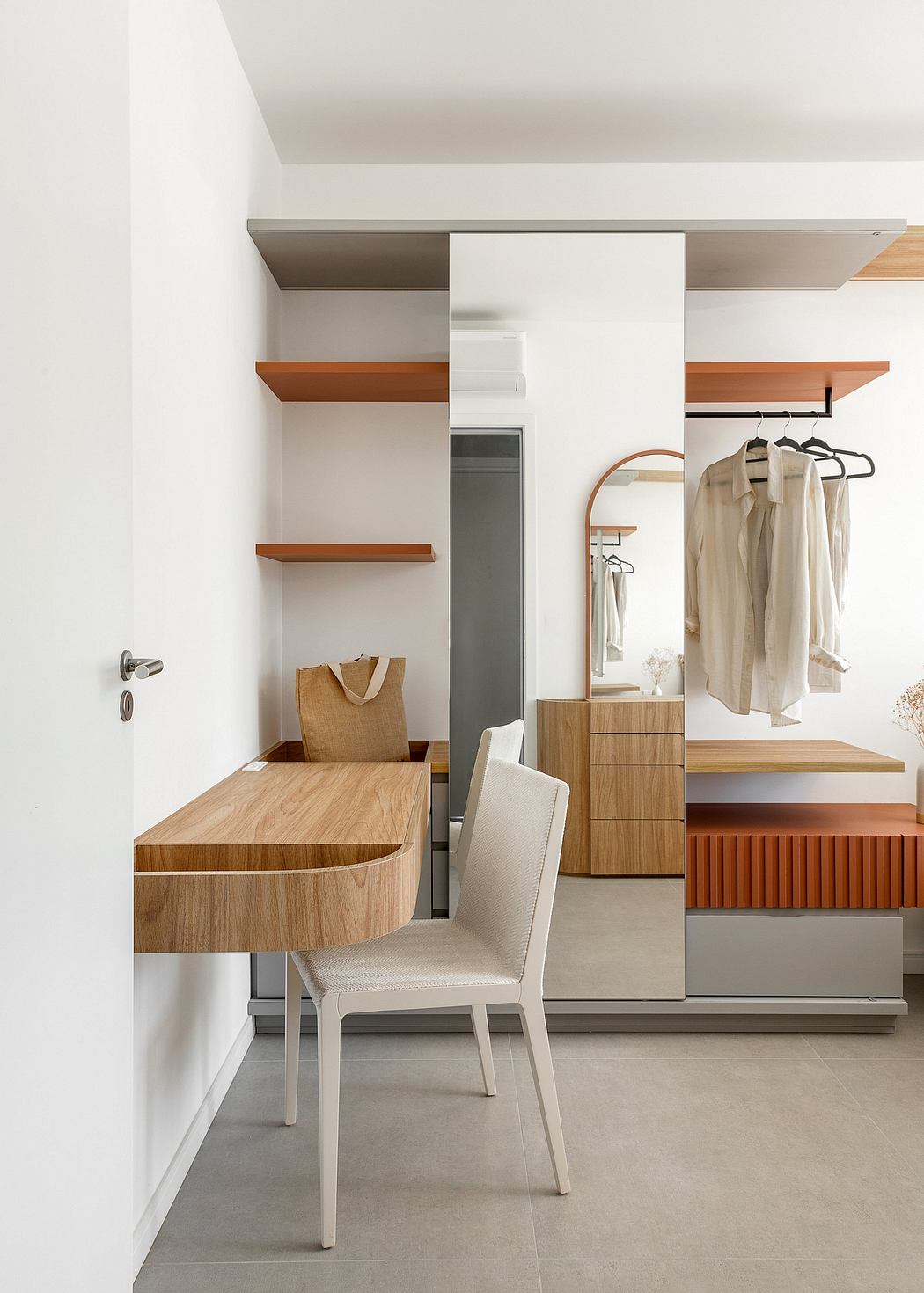 The image showcases a modern, minimalist interior design with warm wood accents, built-in storage, and a sleek vanity.