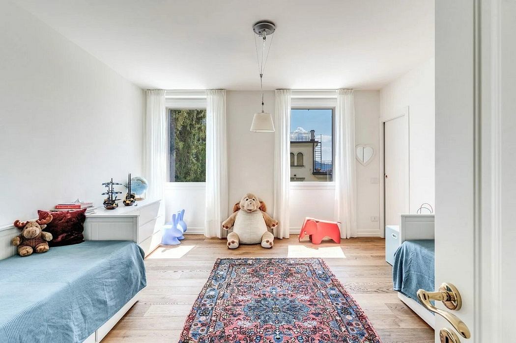 Spacious, bright room with large windows, plush rug, and cozy furniture arrangement.