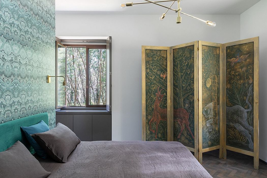 Cozy bedroom with large window, nature-inspired screen, and modern lighting fixture.