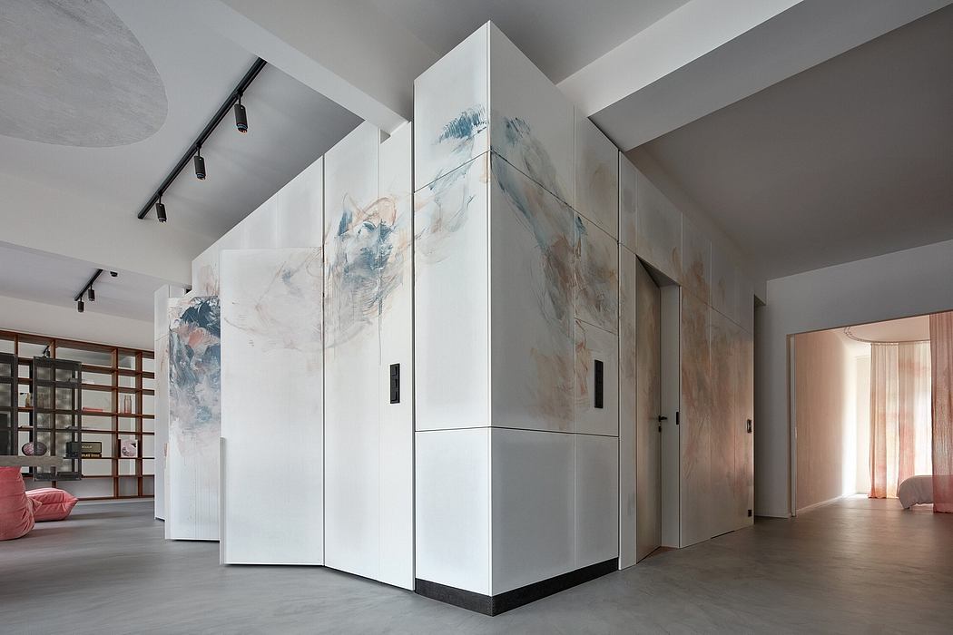 Minimalist interior with large abstract artworks, built-in storage units, and neutral color palette.