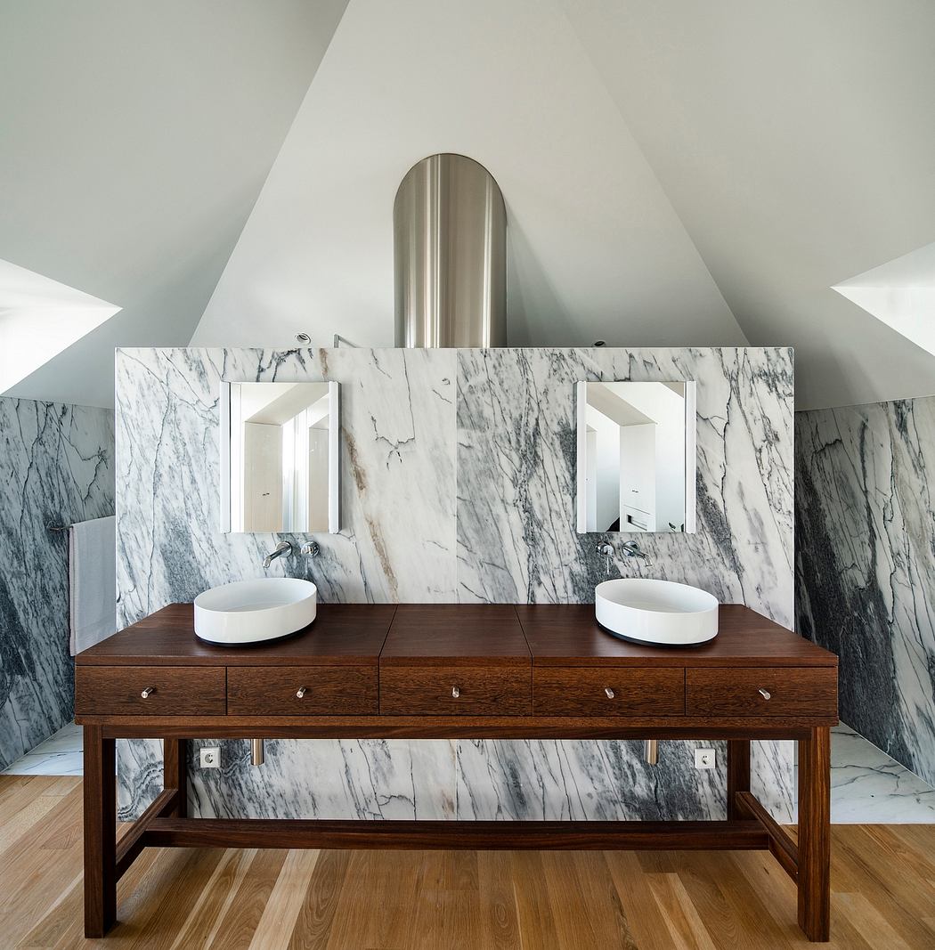 Sleek, minimalist bathroom design with marble walls and wooden vanity.