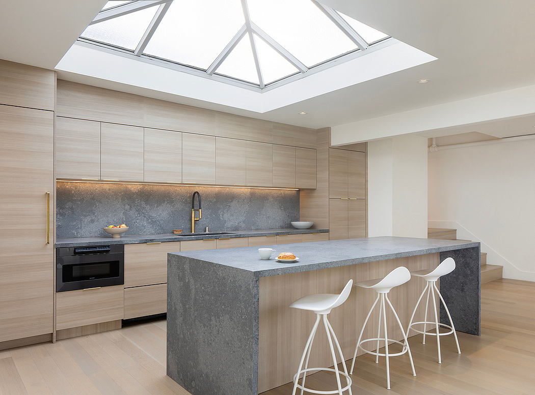 Sleek, modern kitchen with minimalist design and large glass skylight creating a bright, airy space.