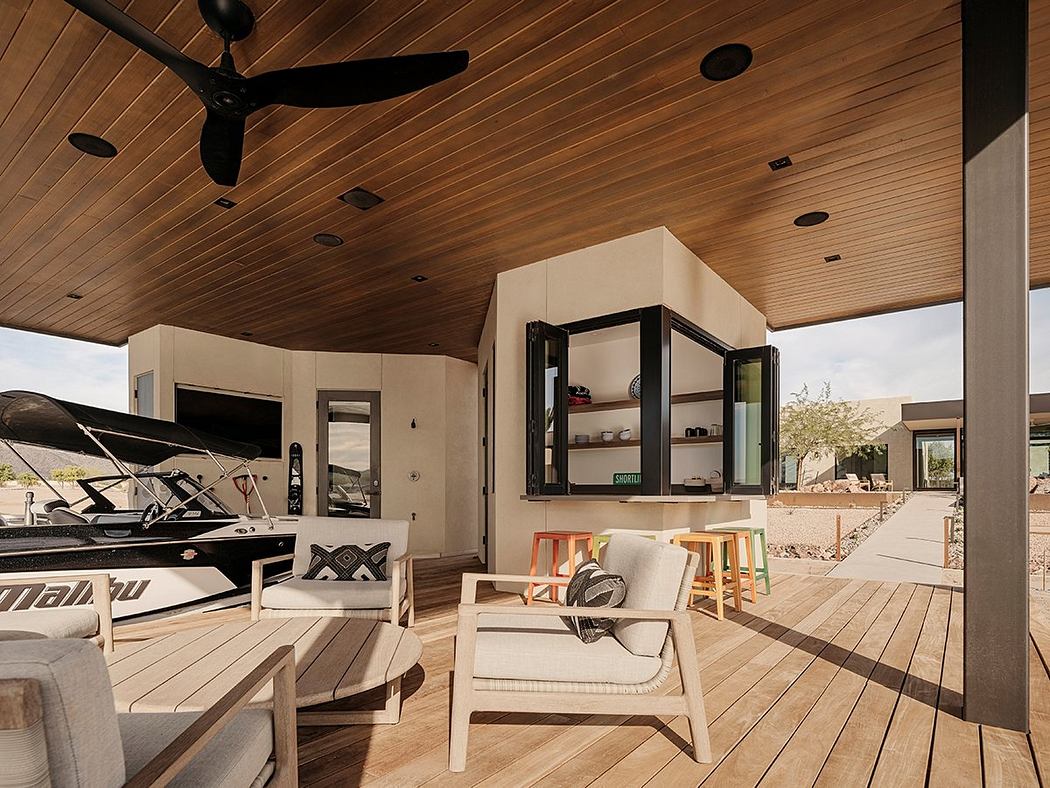 Spacious outdoor living area with wooden beams, modern furniture, and shelving unit.