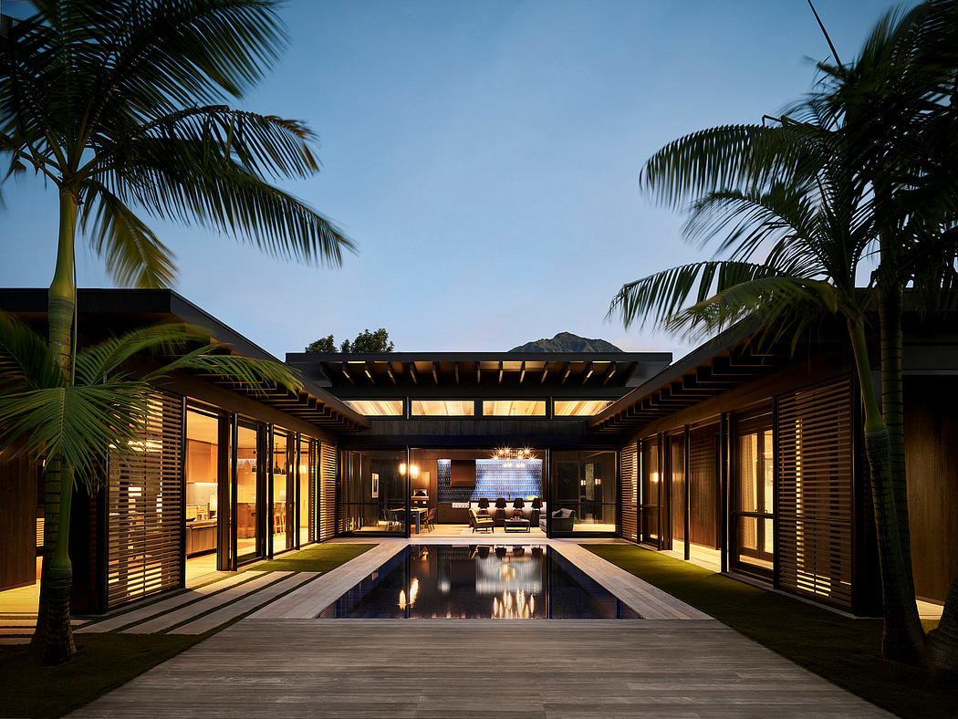 Stunning tropical villa with sleek wooden architecture, pool, and lush palm trees.