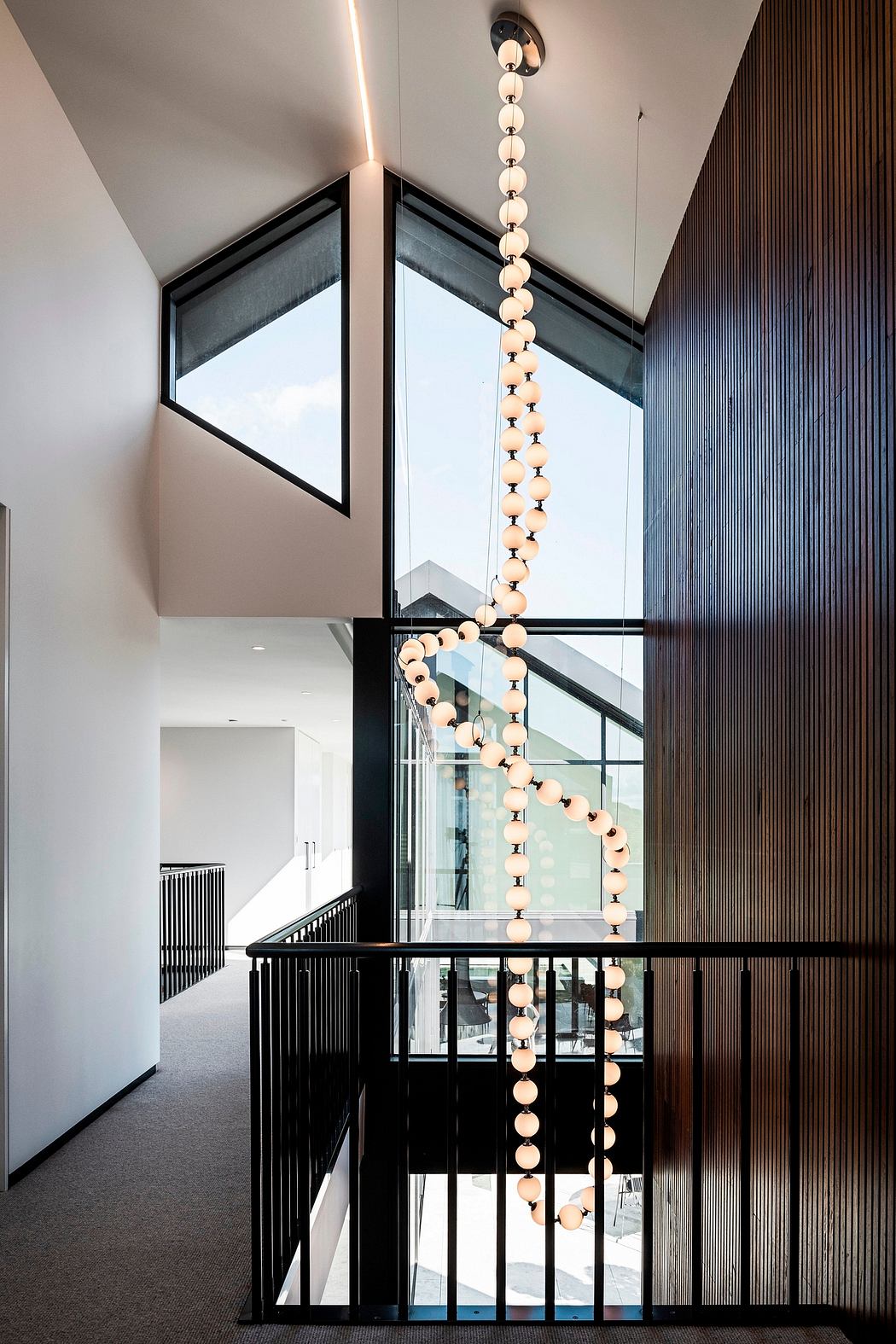 Dramatic light fixtures accent the modern architectural design with clean lines.