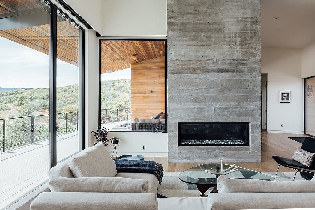 Sleek modern living room with concrete walls, wood paneling, and a fireplace.