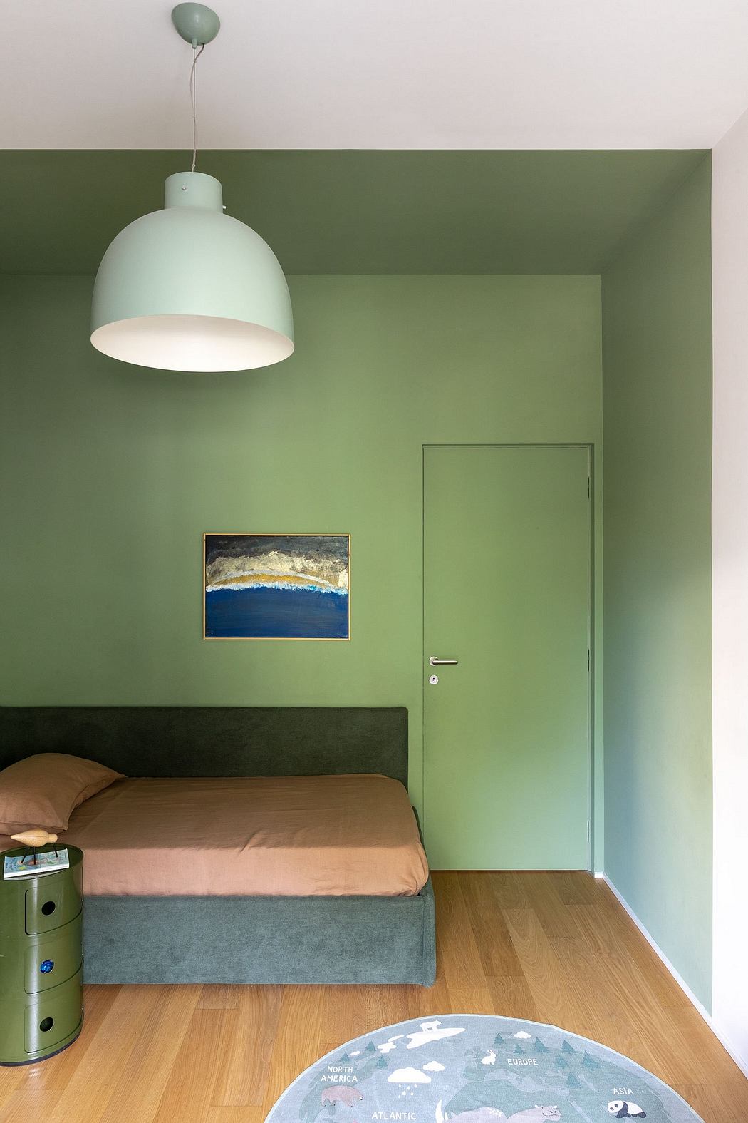 Minimalist bedroom with vibrant green walls, hanging light fixture, and landscape painting.