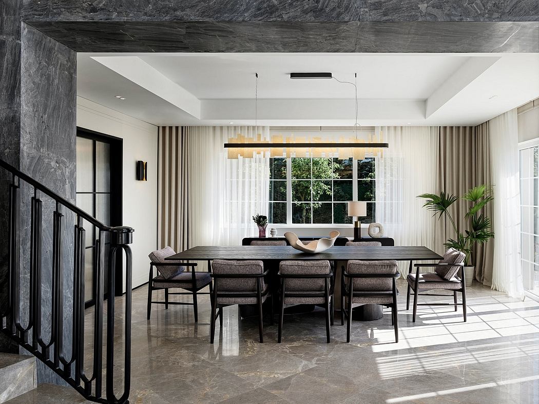 Elegant modern dining room with sleek furniture, large windows, and natural stone accents.