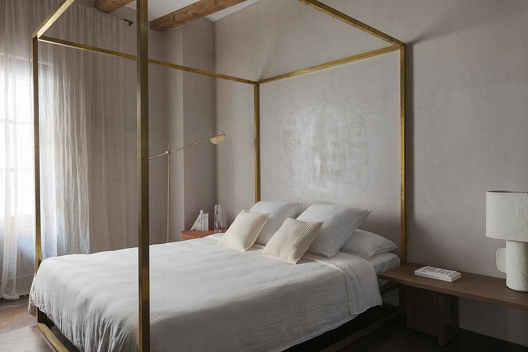 Elegant bedroom with a canopy bed, wooden beams, and minimalist decor.