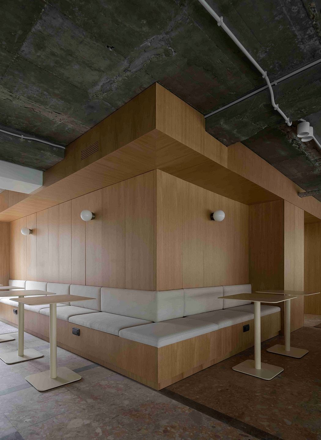 Modern wood-paneled lounge with built-in seating and minimalist furnishings.