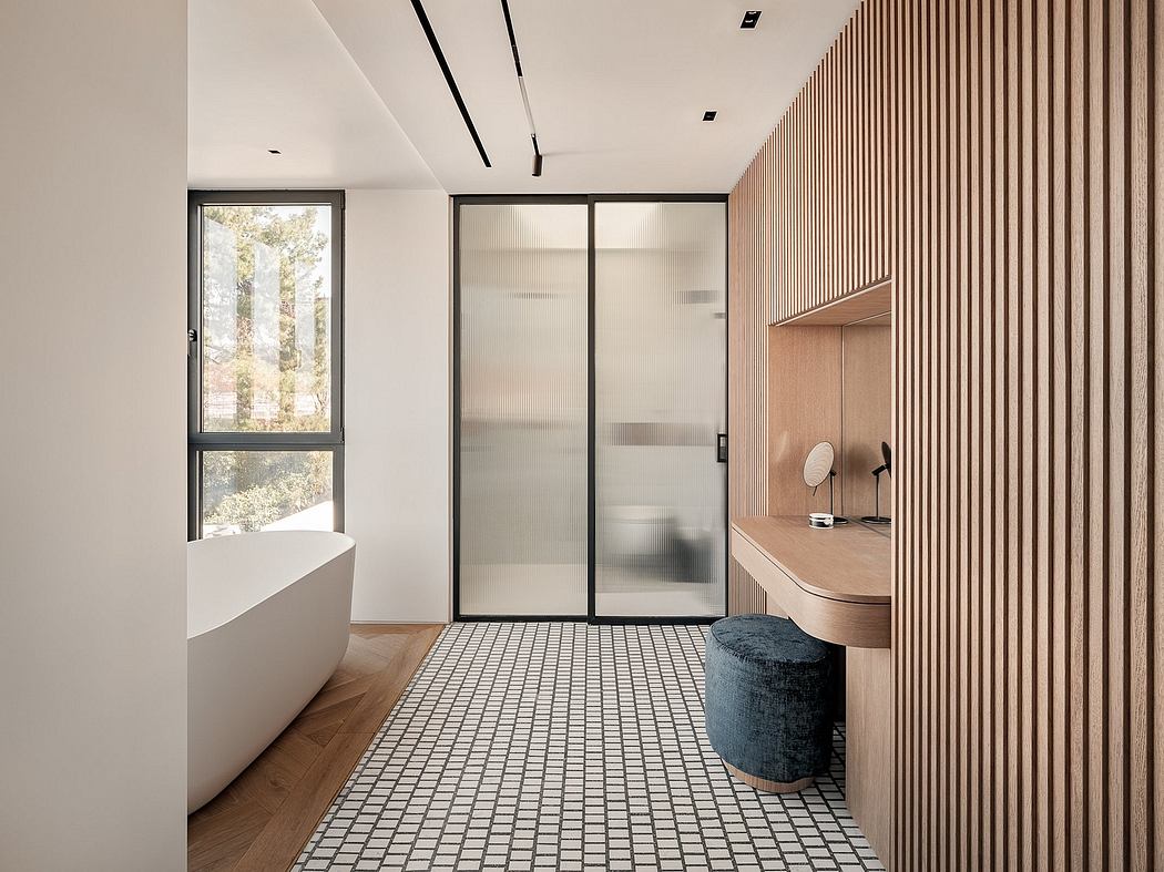 Modern bathroom with wood-paneled walls, tiled floor, and glass shower enclosure.