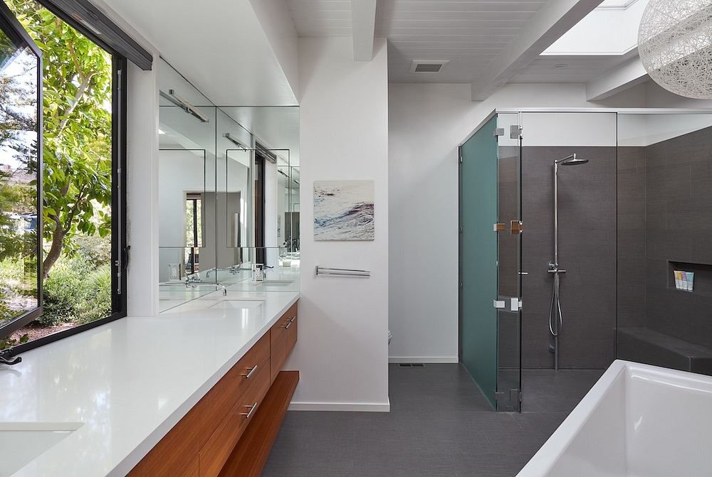 A sleek, modern bathroom with clean lines, natural lighting, and high-end fixtures.