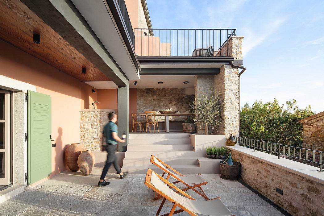 A modern rustic patio with stone walls, wooden beams, and a cozy outdoor seating area.