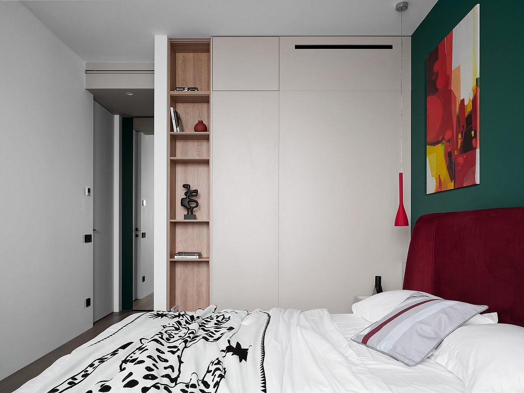 Minimalist bedroom with built-in shelving, vibrant artwork, and clean lines.