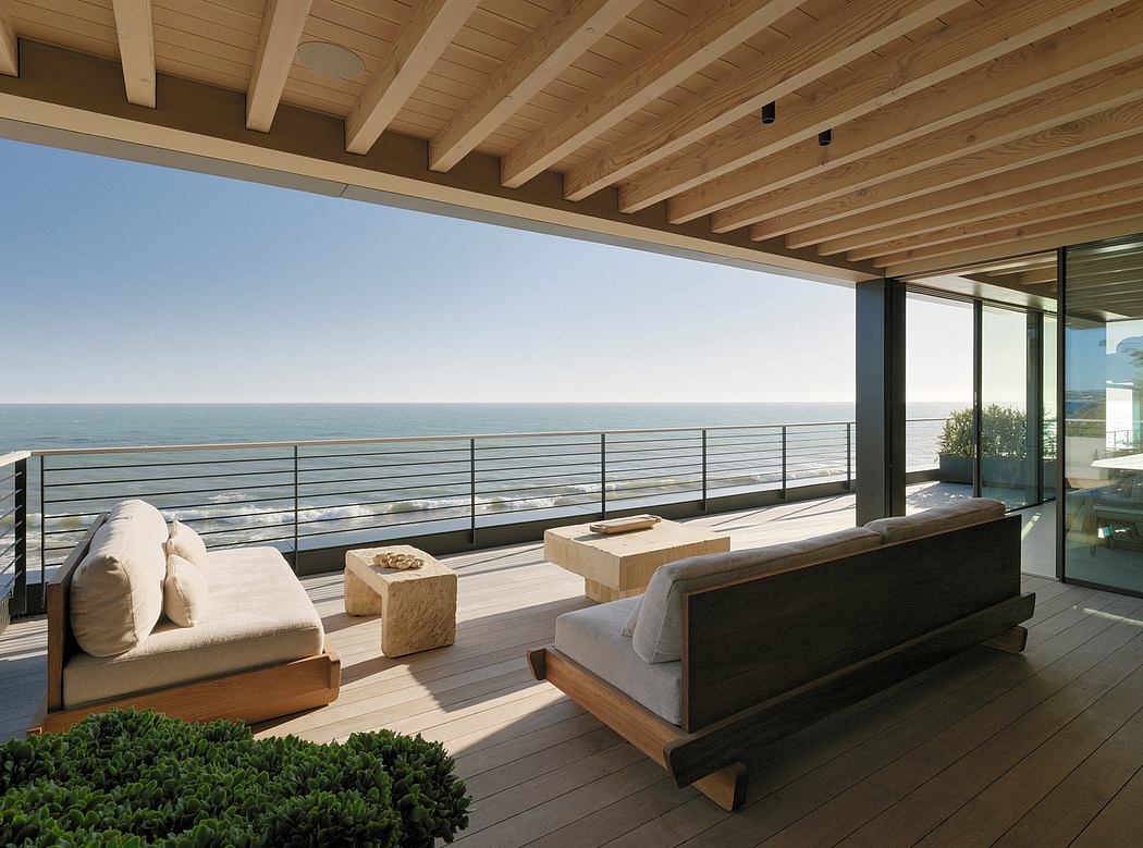 Stunning deck with panoramic ocean views, modern wood and glass architecture.