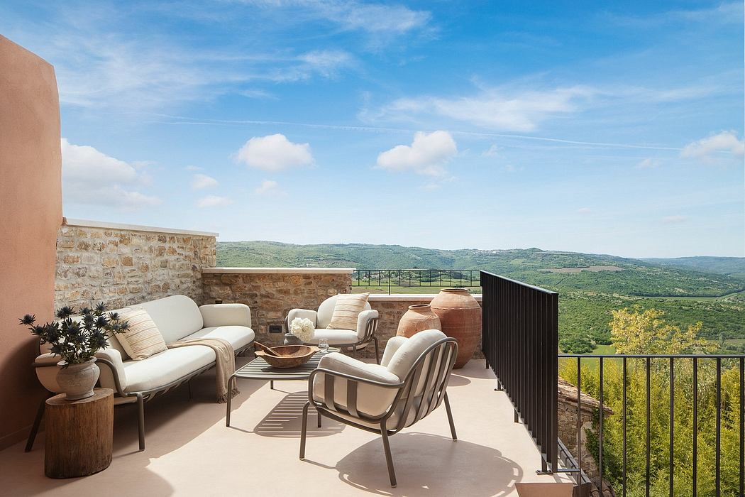 Rustic outdoor terrace with cozy seating area and breathtaking countryside views.