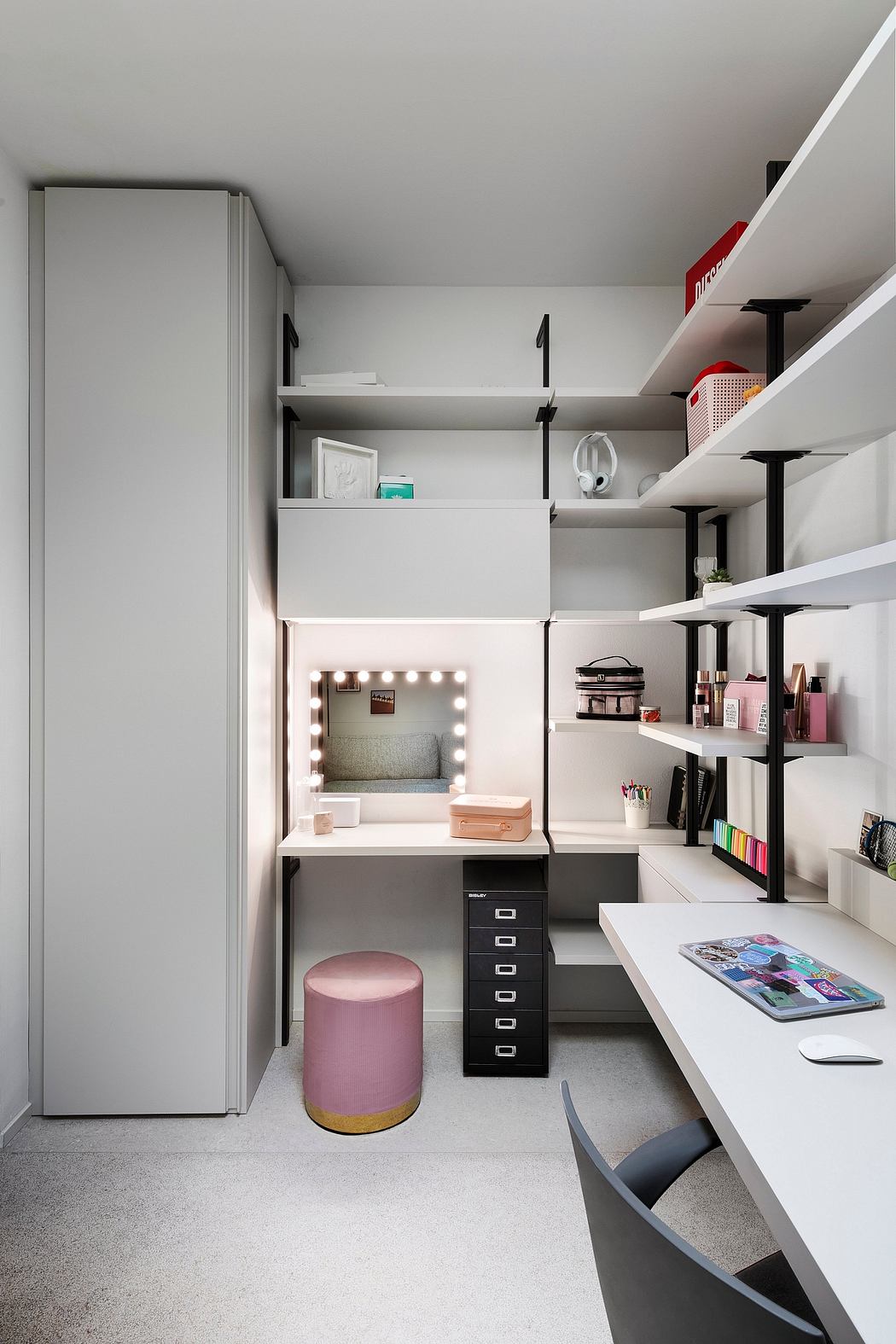 A compact, well-organized home office space with modular shelving, a vanity, and storage.
