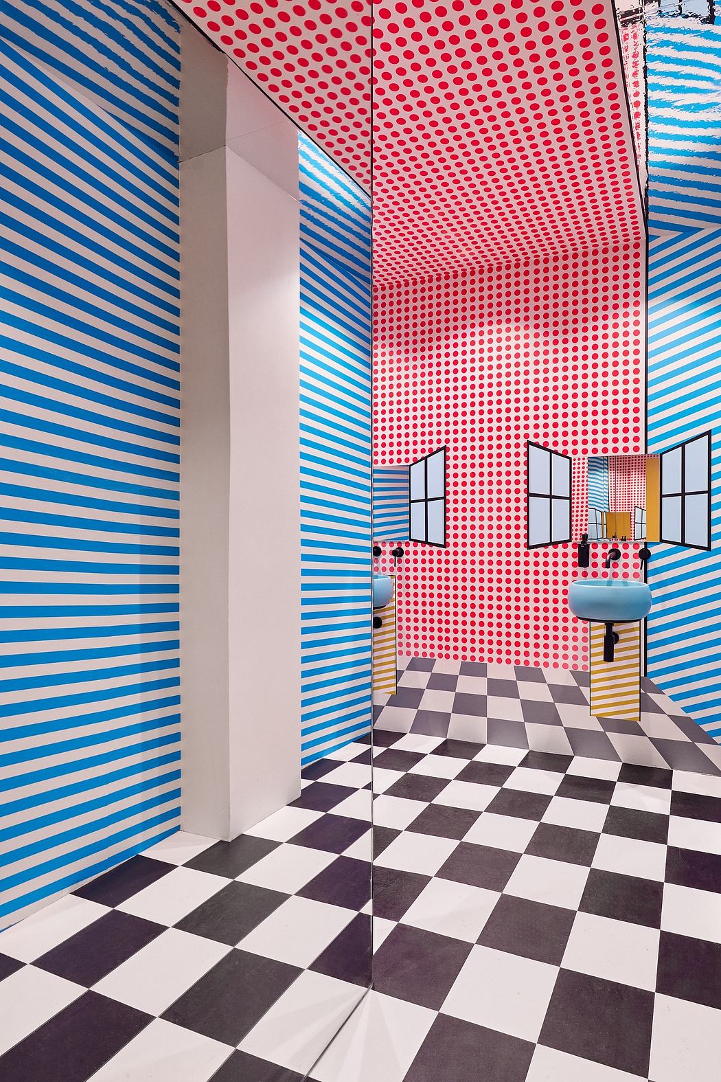 A vibrant, geometric interior featuring bold stripes, dots, and a checkered floor.