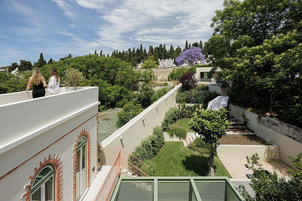 A scenic garden landscape with a modern white building, lush greenery, and arched windows.