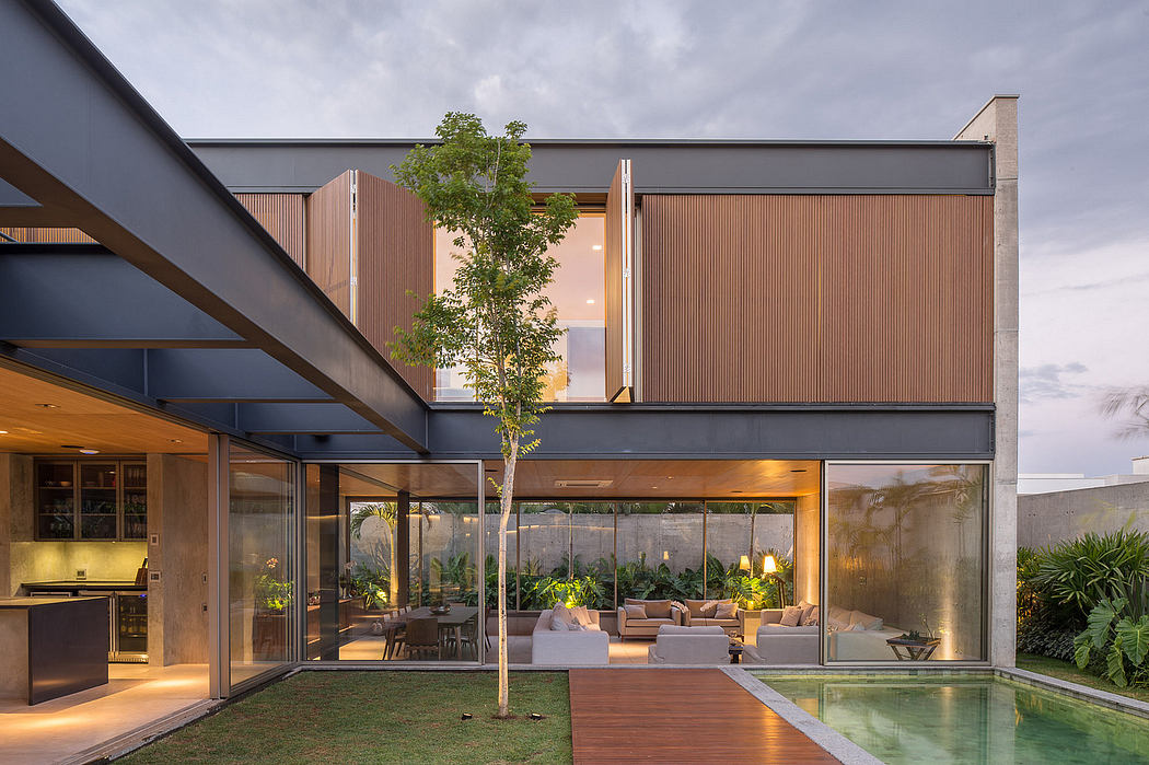 Modern architectural design with expansive glass walls, wooden structures, and an outdoor pool.