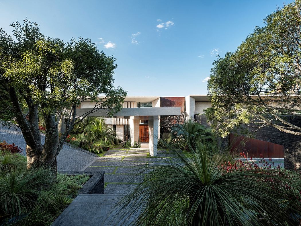 An elegant modern home nestled among lush tropical vegetation, featuring clean lines and inviting outdoor spaces.