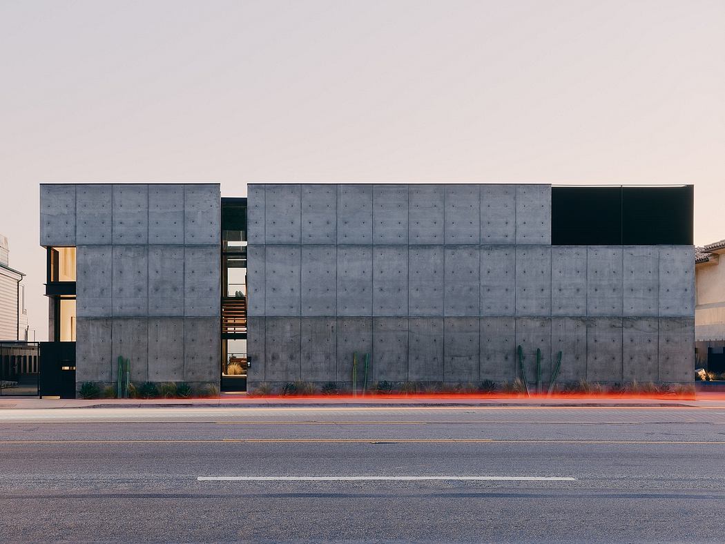 A modern, concrete building with sleek lines, geometric patterns, and strategic lighting.