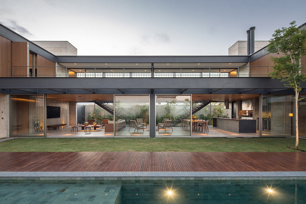 Modern, multilevel home with glass walls, wooden deck, and swimming pool. Sleek, minimalist design.