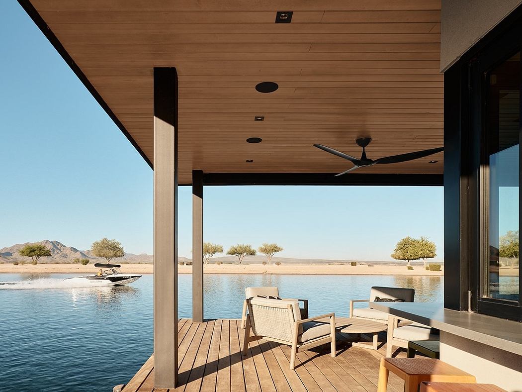 Spacious lakefront deck with wooden ceiling, modern furniture, and scenic mountain view.