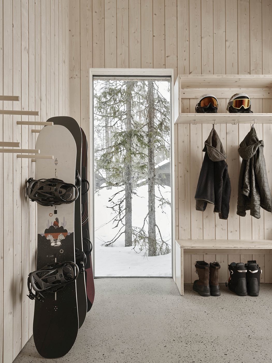 Cozy winter cabin interior featuring wooden walls, snowscape, and snowboarding gear.