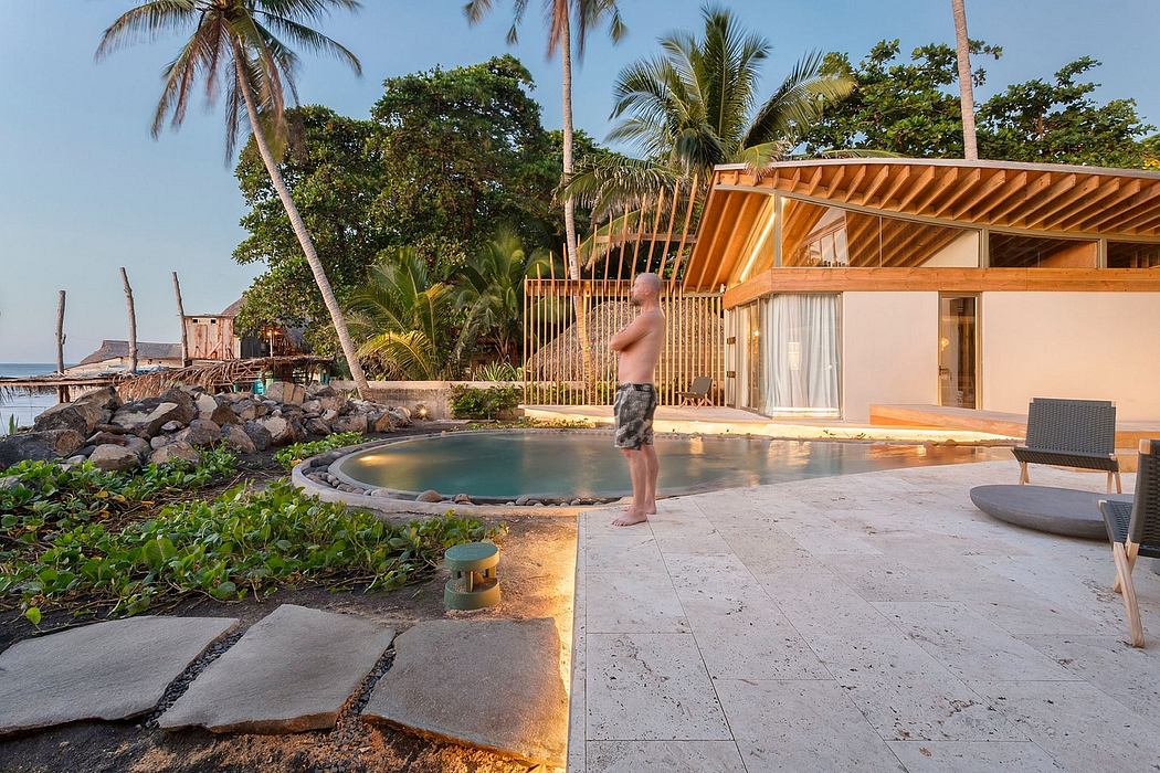 Tropical resort with wooden beams, pool, and lush vegetation surrounding the property.