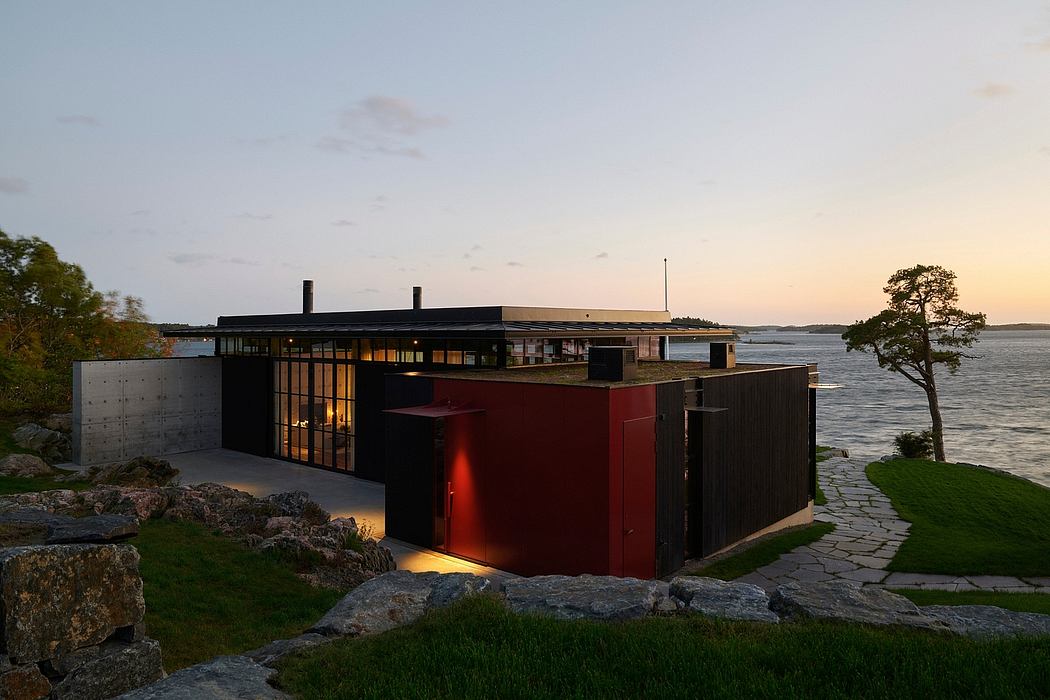 A contemporary waterfront structure with geometric forms, natural materials, and lighting.