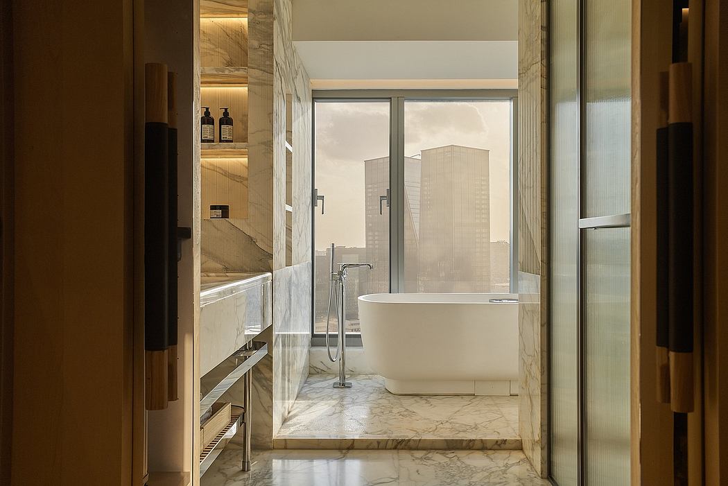 Luxurious modern bathroom with freestanding tub, marble floors, and cityscape view.