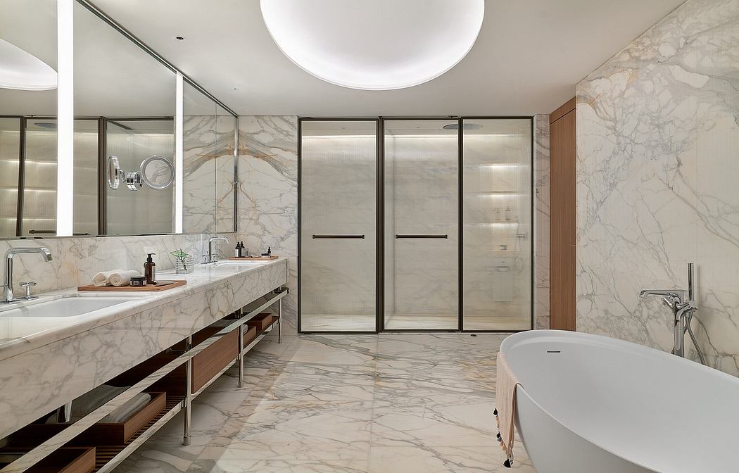 Sleek, modern bathroom with marble vanity, glass-enclosed shower, and freestanding tub.