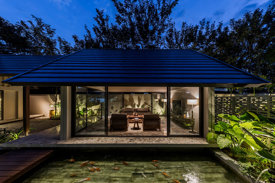 Contemporary tropical pavilion with glass walls, dark wood roof, and reflection pool.