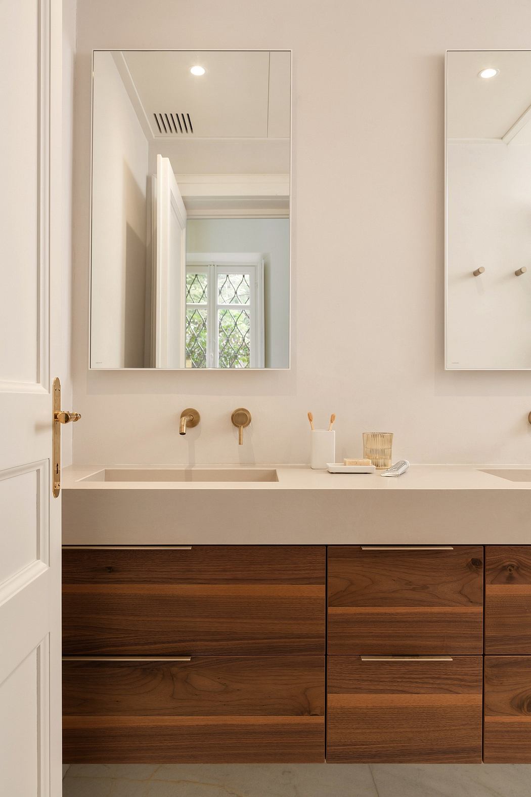 A modern bathroom with clean lines, warm wood cabinets, and a sleek white vanity.