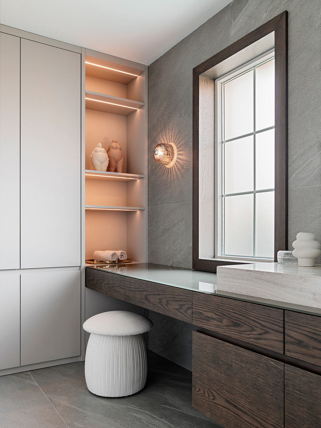 Clean, modern bathroom design with built-in cabinetry, shelving, and a sleek vanity.