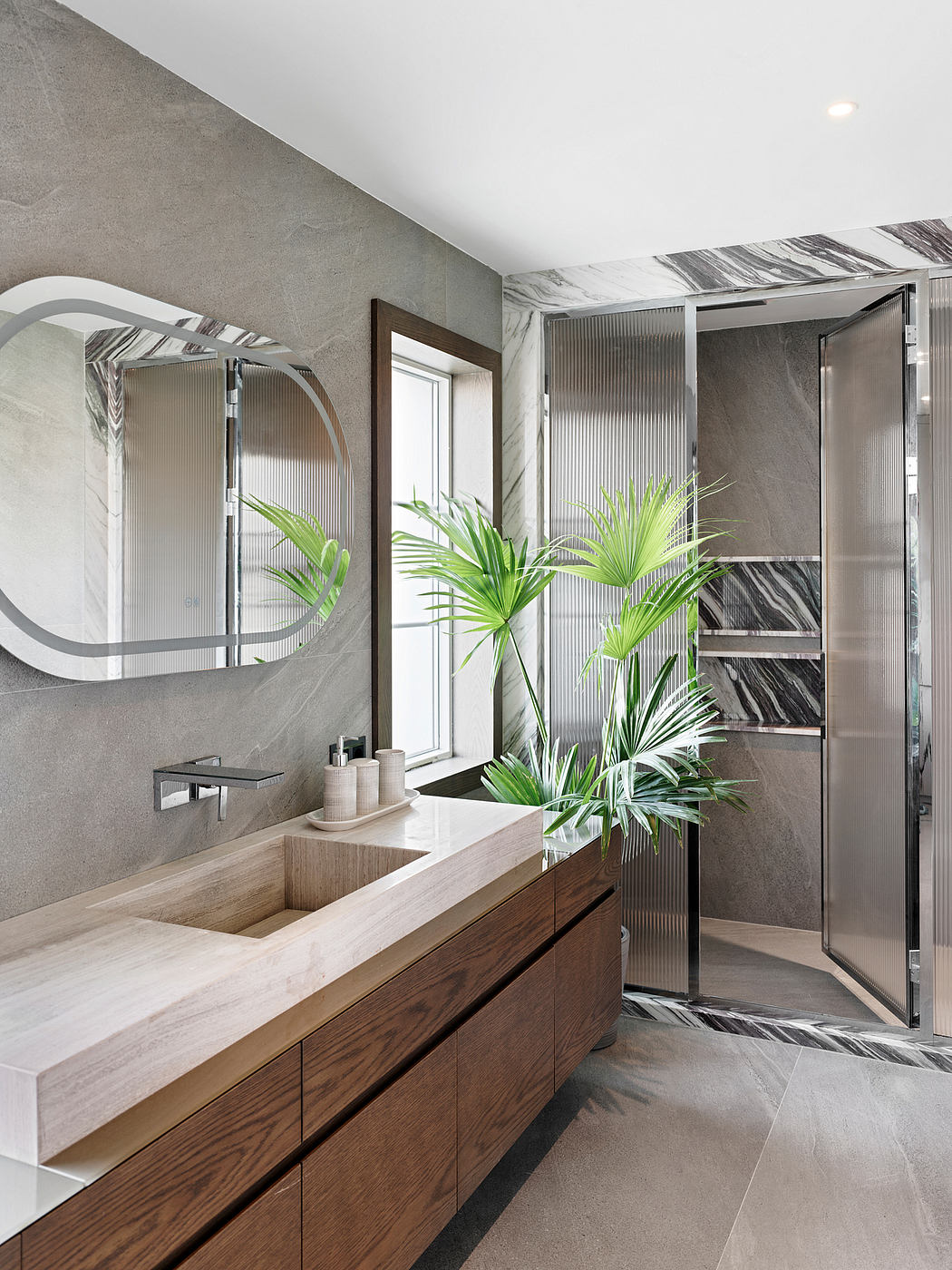 Sleek, modern bathroom design with wood vanity, marble accents, and lush tropical plants.