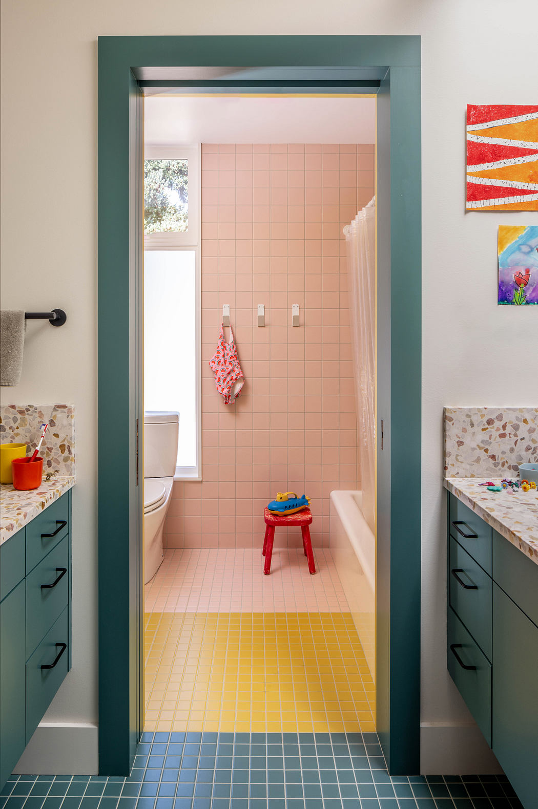 A vibrant bathroom with a retro-inspired color palette and unique tiled floors.